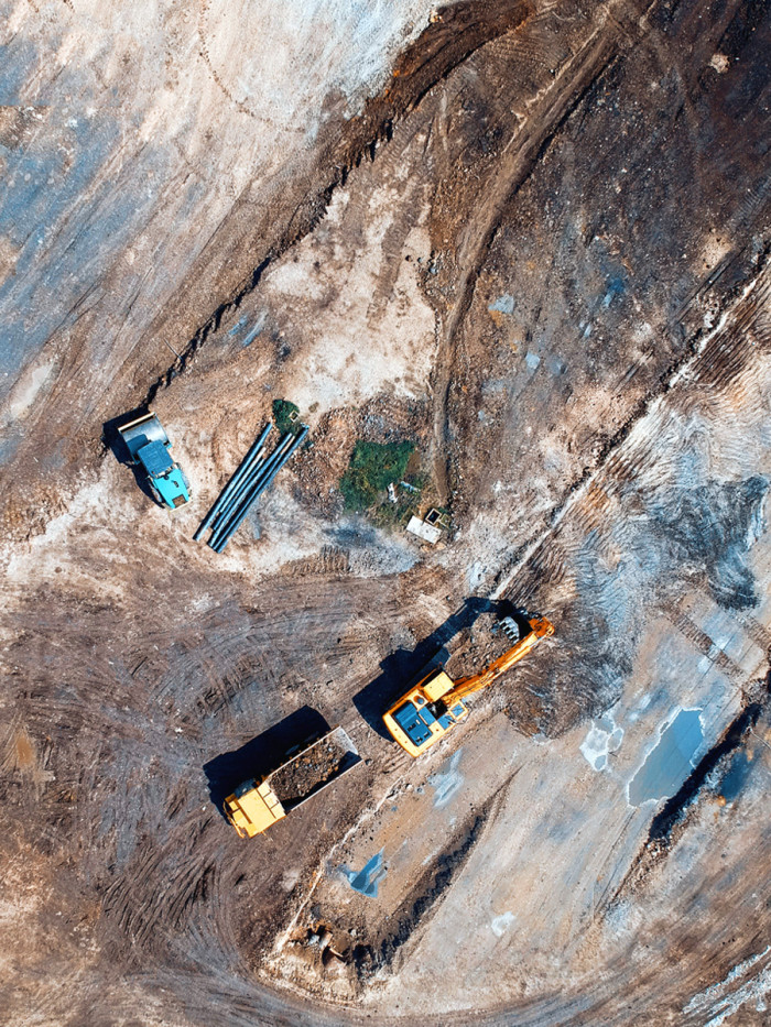Aerial view of construction machinery on a building site.